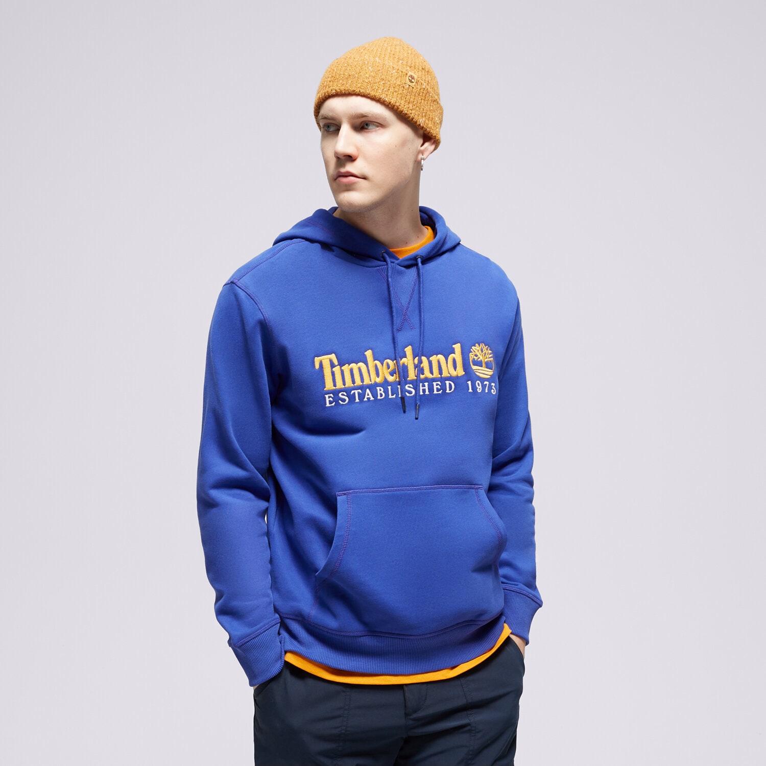 pánská mikina TIMBERLAND MIKINA S KAPUCÍ LS 50TH ANNIVERSARY EST. 1973 TB0A6S5WED51 MODRÁ