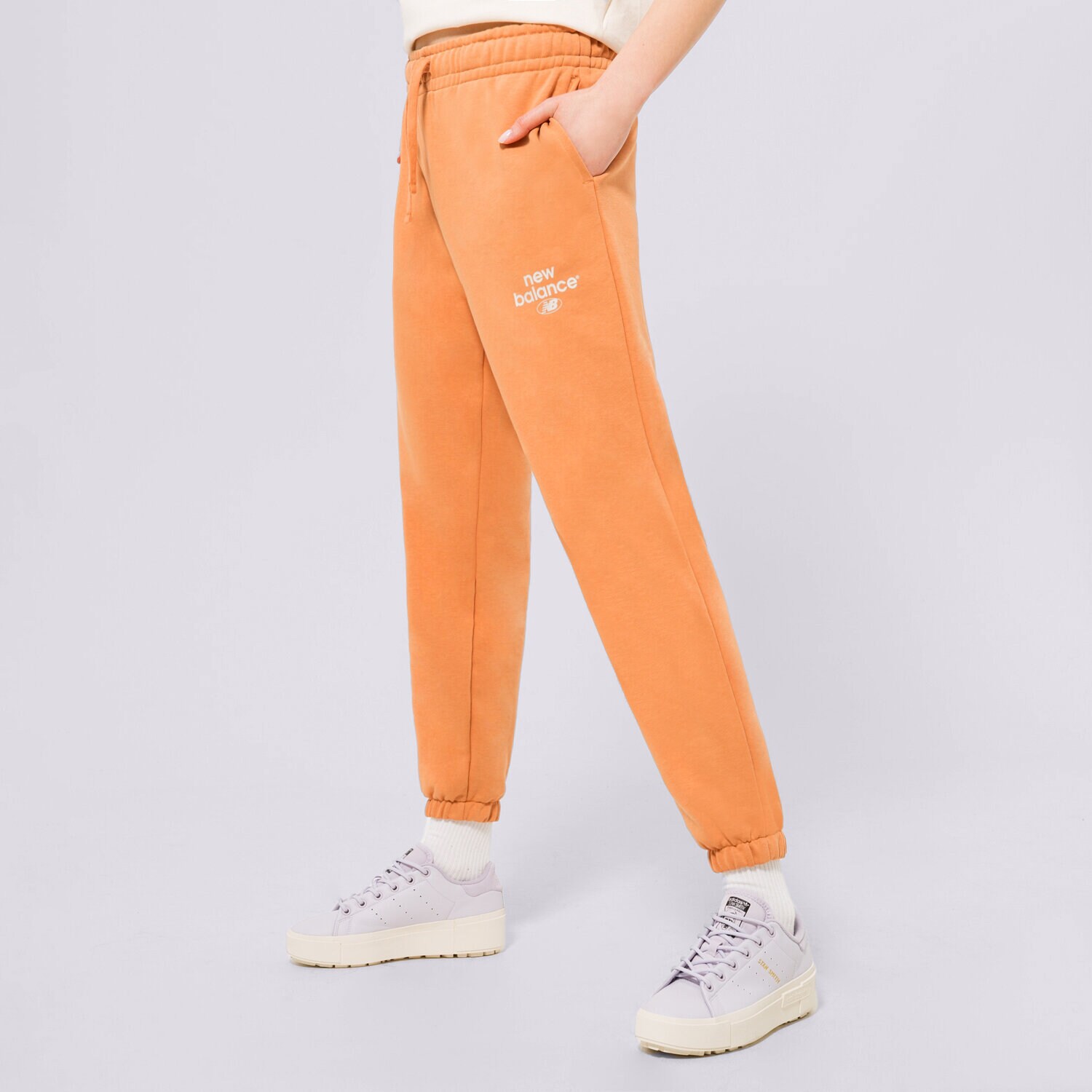 dámské kalhoty NEW BALANCE KALHOTY  NB ESSENTIALS GRAPHIC FLEECE WP31508SEI ORANŽOVÁ