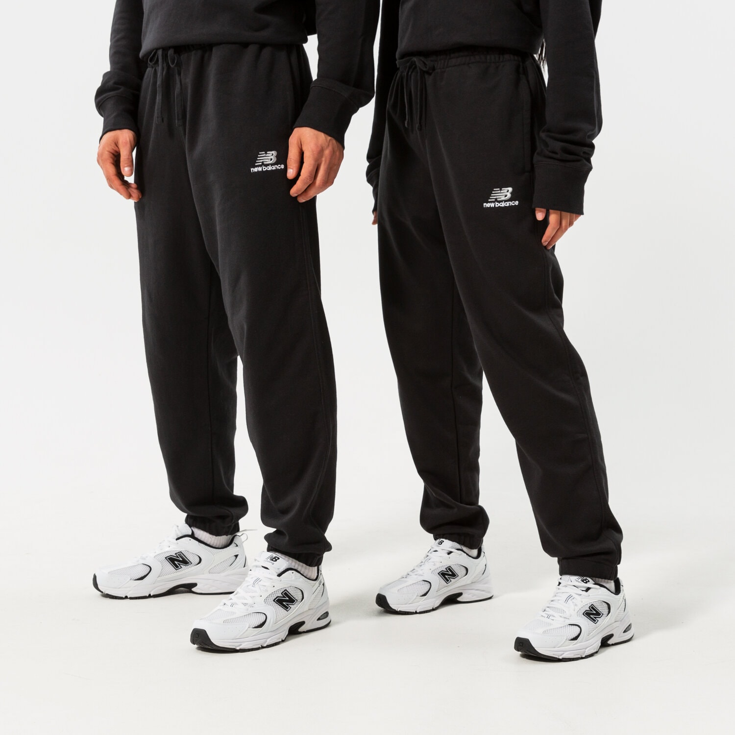 dámské kalhoty NEW BALANCE KALHOTY  NB ESSENTIALS UNI-SSENTIALS SWEATPANT UP21500BK ČERNÁ